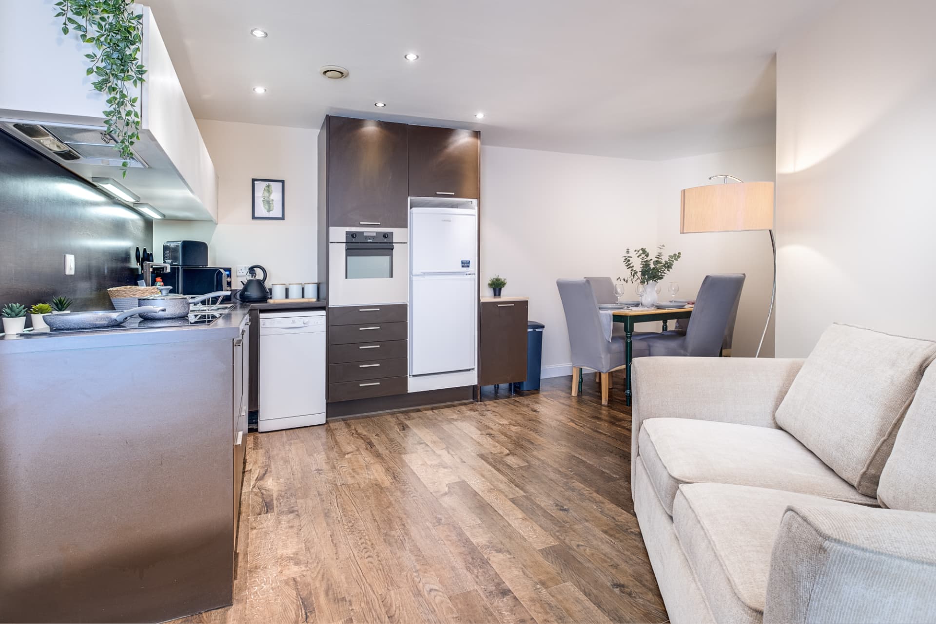 Open-plan kitchen, dining and lounge with warm oak flooring