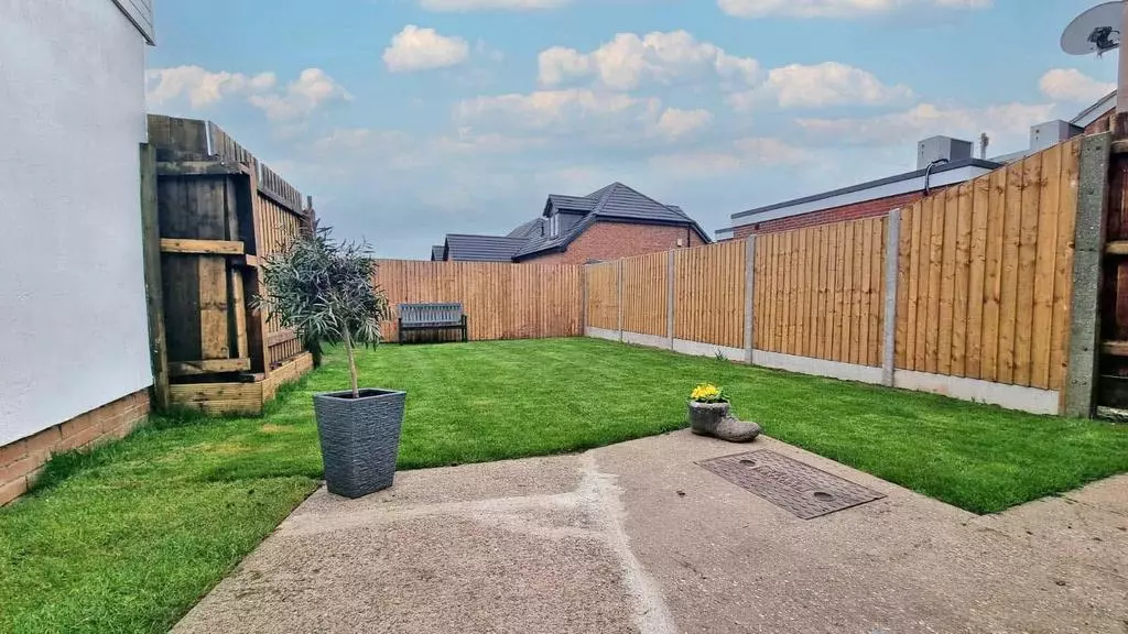 Landscaped rear garden with new lawn, fresh fencing and paved patio area