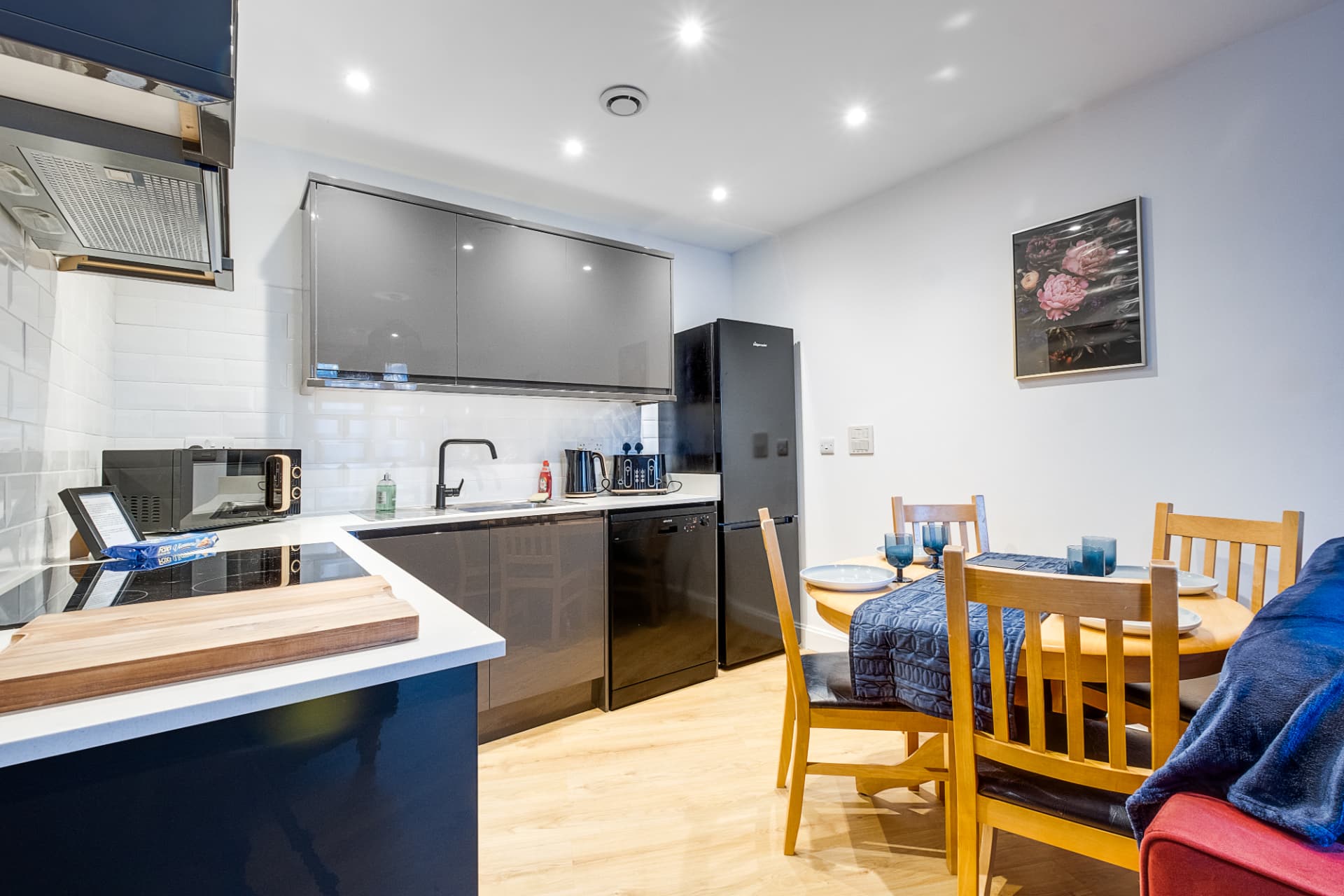 Modern kitchen with integrated appliances and adjacent dining table