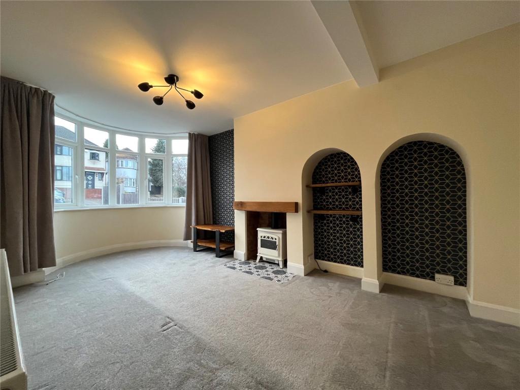 Completed living room with bay window, feature fireplace and arched alcoves