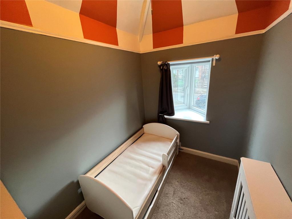 Bedroom before works with dark walls and painted striped ceiling