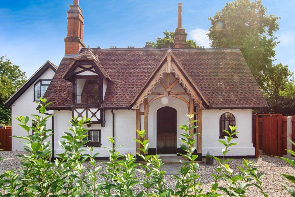 Completed front elevation of Project White Gables with restored brick chimneys, timber porch and white render