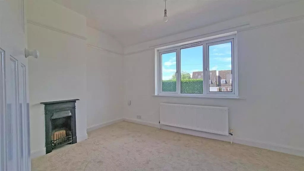 Double bedroom with cast iron fireplace, new carpet and freshly decorated walls