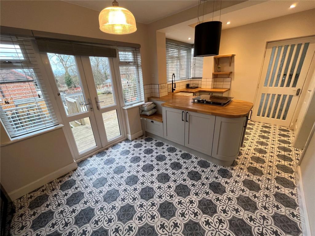 Kitchen diner with French doors to the garden and patterned tiled flooring